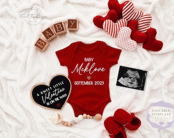 May include: A red onesie with the text "BABY Mcklove" and "SEPTEMBER 2023" on it. A black heart-shaped chalkboard sign reads "A SWEET LITTLE VALENTINE IS ON THE WAY!"  There are red and white heart-shaped decorations and wooden blocks spelling "BABY".