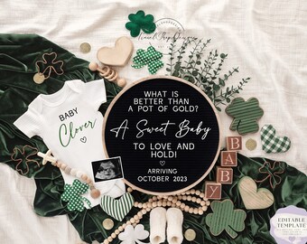 May include: A green velvet background with a white onesie that says "Baby Clover" and a black letter board that says "What is better than a pot of gold? A Sweet Baby to Love and Hold! Arriving October 2023". There are also green shamrocks, wooden blocks that spell "Baby", and a wooden heart.