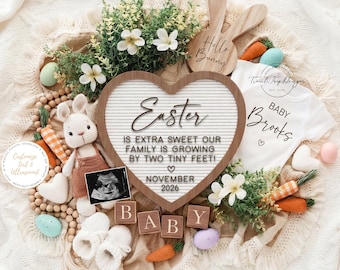 May include: A heart-shaped sign with the word "Easter" and the message "Is extra sweet our family is growing by two tiny feet!" surrounded by Easter-themed decorations. Includes a baby onesie, a stuffed bunny, and wooden blocks.