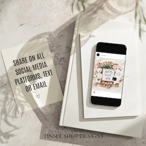 May include: A smartphone displays a baby announcement on a white notebook. The announcement includes a teddy bear, baby clothes, and wooden blocks spelling "BABY". A card reads "SHARE ON ALL SOCIAL MEDIA PLATFORMS, TEXT OR EMAIL".