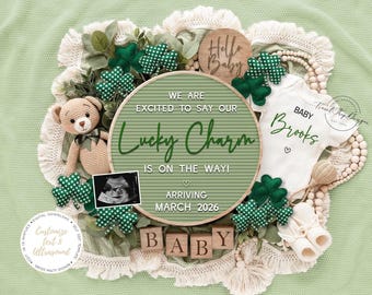 May include: A baby announcement with a green theme. The announcement includes a round sign with the text "Lucky Charm is on the way!" and "Arriving March 2026." It also features a baby onesie, wooden blocks spelling "BABY," and shamrock decorations.