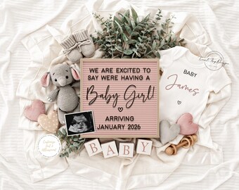 Könnte beinhalten: Baby-Ankündigung mit einer rosa Buchstaben-Tafel mit der Aufschrift "Wir freuen uns, Ihnen mitteilen zu können, dass wir ein Baby Girl bekommen! Ankunft Januar 2026." Enthält einen weißen Body mit "Baby James" und ein Ultraschallbild. Außerdem ein Stoffelefant, Babyschuhe und Holzblöcke.