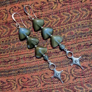 May include: A pair of silver dangle earrings with green and blue gemstone beads and a silver charm at the bottom.