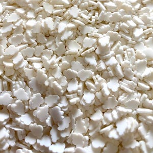 May include: White cloud shaped sprinkles for baking and decorating. These small, white sprinkles are perfect for adding a touch of whimsy to cakes, cupcakes, cookies, and other treats.