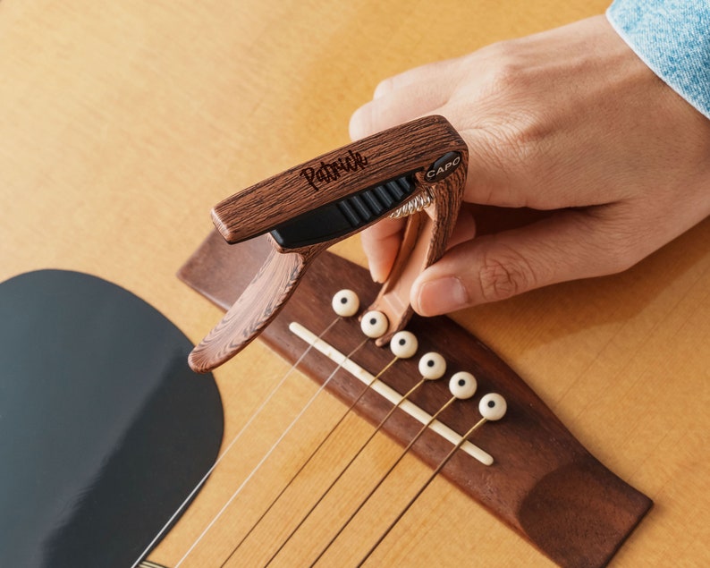 a person playing a guitar with a guitar picker