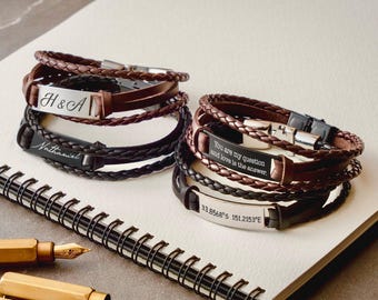 May include: Four multi-strand bracelets made of braided brown and black leather with metallic plates. The plates feature engravings: H & A, Nathaniel, You are my question and love is the answer, and the coordinates 33.8568° S 151.2153° E.