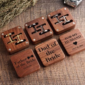 May include: Six wooden boxes with engraved text and a heart symbol. The boxes are for cufflinks and have a dark brown finish. The text on the boxes includes "Dad of the Bride", "Father of the Bride", "For My Husband", and "Oct 02, 2024".