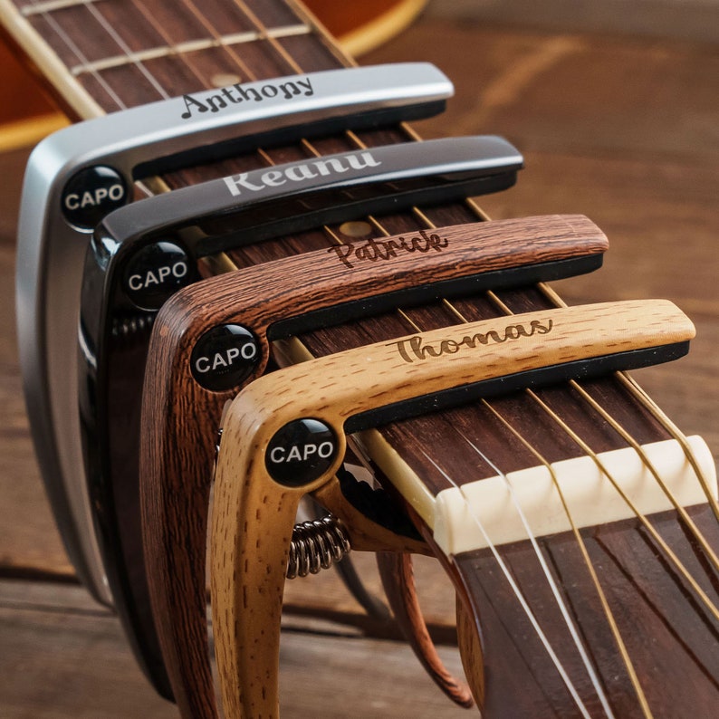 a guitar neck with a guitar picker next to it