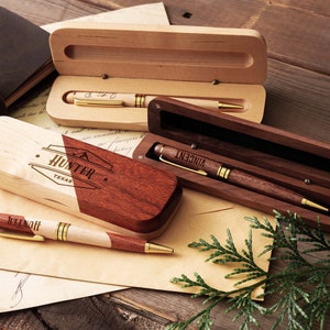 a couple of wooden pens sitting on top of a piece of paper