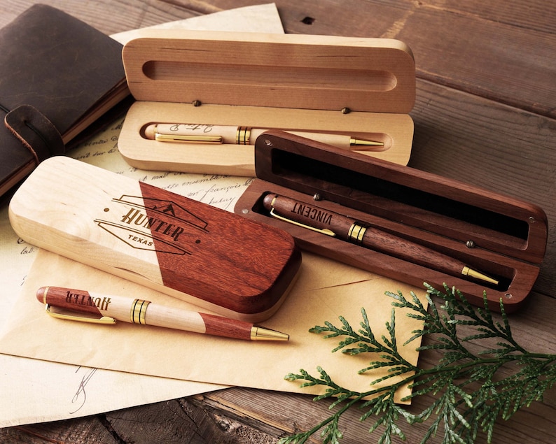 a couple of wooden pens sitting on top of a piece of paper