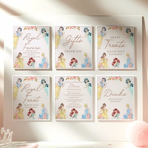 May include: Six framed signs with princess designs. The signs feature text like "Royal Favours," "Gifts," "Sweet Treats," "Royal Feast," "Drinks," and a menu. Floral accents and princess illustrations decorate the signs.