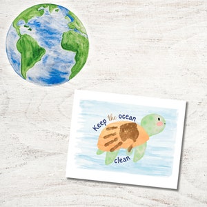 May include: A watercolor illustration of a sea turtle with a handprint on its shell. The text "Keep the ocean clean" is written below the turtle.