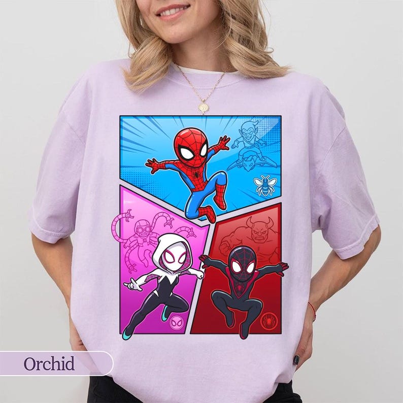 May include: Orchid-colored t-shirt featuring a comic book-style graphic of Spider-Man and other characters. The graphic is divided into panels with a blue, pink, and red color scheme. The word "Orchid" is printed at the bottom.