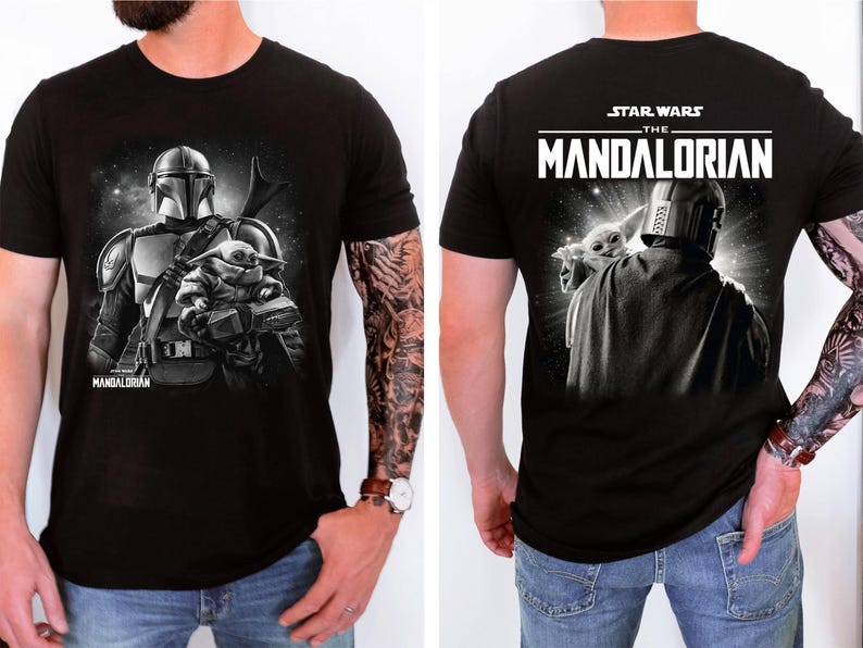 May include: Black t-shirt featuring a graphic of The Mandalorian and Grogu from Star Wars. The front shows the Mandalorian with Grogu, and the back displays the Star Wars: The Mandalorian logo and a similar image. The shirt is short-sleeved.