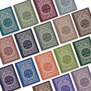 May include: A collection of notebooks with the text "KEEPING SCORE game night" in various colors. The notebooks have an ornate, vintage-style design with a circular central element and decorative borders. Colors include teal, green, burgundy, and blue.