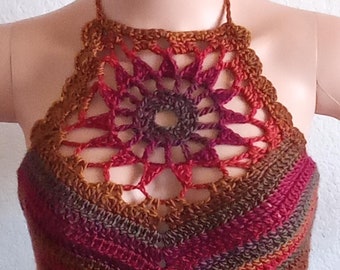May include: A handmade crochet halter top in shades of brown, red, and orange. The top features a detailed floral design at the neckline and a scalloped edge. The halter straps are also crocheted.