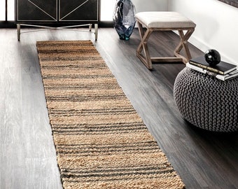 May include: A natural fibre runner rug with a striped pattern in beige and grey. The rug is made of jute and is perfect for adding a touch of natural texture to any room.