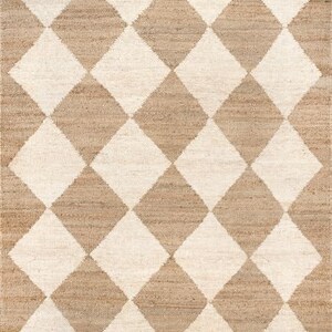 May include: A brown and white jute rug with a diamond pattern. The rug has a woven texture and is made of natural fibres.