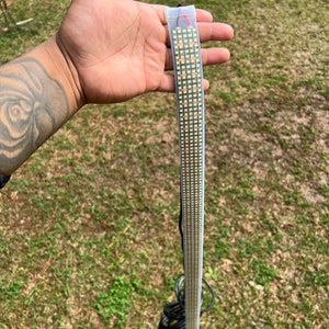 May include: A long strip of white LED lights in a clear plastic bag. The lights are arranged in a grid pattern and are connected to a black wire.