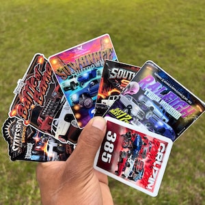 May include: A collection of colorful event stickers featuring trucks and the text "Battle Born", "Swanner Shutdown", "South", "Truck Invasion", and "Cruzin". The stickers have various designs and colors, with images of trucks.