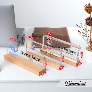 May include: Four clear acrylic desk nameplates with wooden bases. The nameplates are 7.8 inches, 7 inches, and 2.5 inches long. The nameplates feature personalized text and logos. The nameplates are 0.4 inches thick.