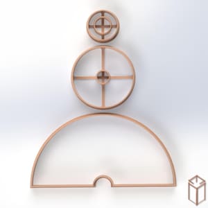 May include: A set of three light brown cookie cutters arranged vertically. The top two are circular with internal cross-shaped supports, while the bottom piece is a large semi-circle with a small arched cutout at the center of the flat base.