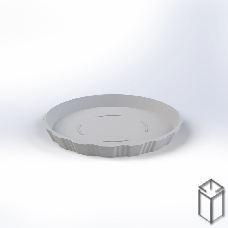 Puede incluir: Una bandeja redonda gris claro, impresa en 3D, con un borde texturizado y acanalado. La bandeja tiene tres hendiduras curvas en el interior. El producto est&aacute; dise&ntilde;ado para sujetar objetos. La bandeja se muestra sobre un fondo blanco.