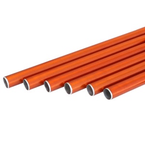 May include: A collection of orange-colored, cylindrical metal tubes with silver-colored ends. The tubes are arranged in a parallel, diagonal pattern against a white background. The tubes appear to be of varying lengths.