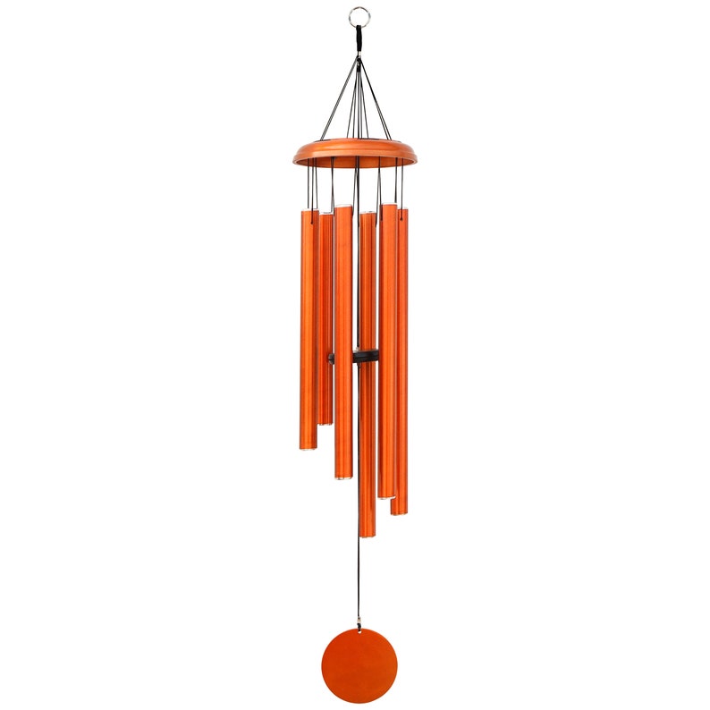 May include: Orange wind chimes with a wooden top and a circular wooden base. The chimes are made of metal tubes and hang from black strings. A circular orange wooden piece hangs at the bottom. The wind chimes are designed for outdoor use.