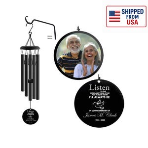 May include: Black wind chime with a memorial design. The chime includes a round pendant with a photo of a couple and a second pendant with the text "Listen to the wind and think of me..." and the name James M. Clark.