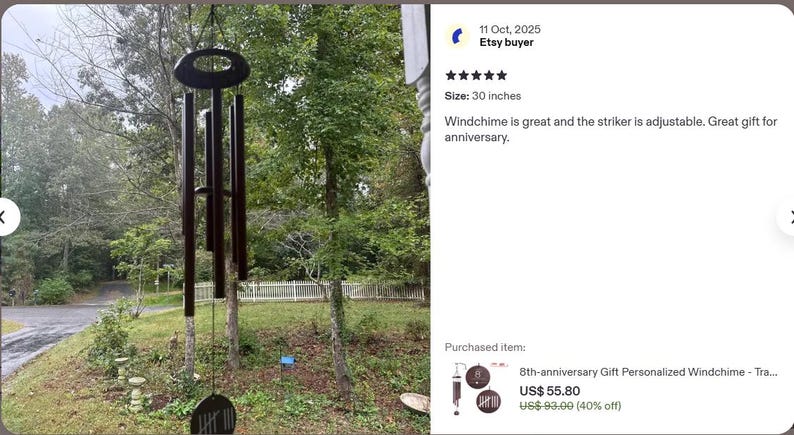 May include: A dark brown wind chime with five cylindrical tubes hanging from an oval-shaped top piece. The wind chime features a circular wind catcher at the bottom and is 30 inches in length as indicated by the product review text.