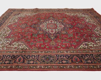 May include: A large rectangular area rug featuring a deep red field with a central cream and navy blue star-shaped medallion. The rug is decorated with intricate floral and geometric patterns throughout, finished with a wide dark navy border.