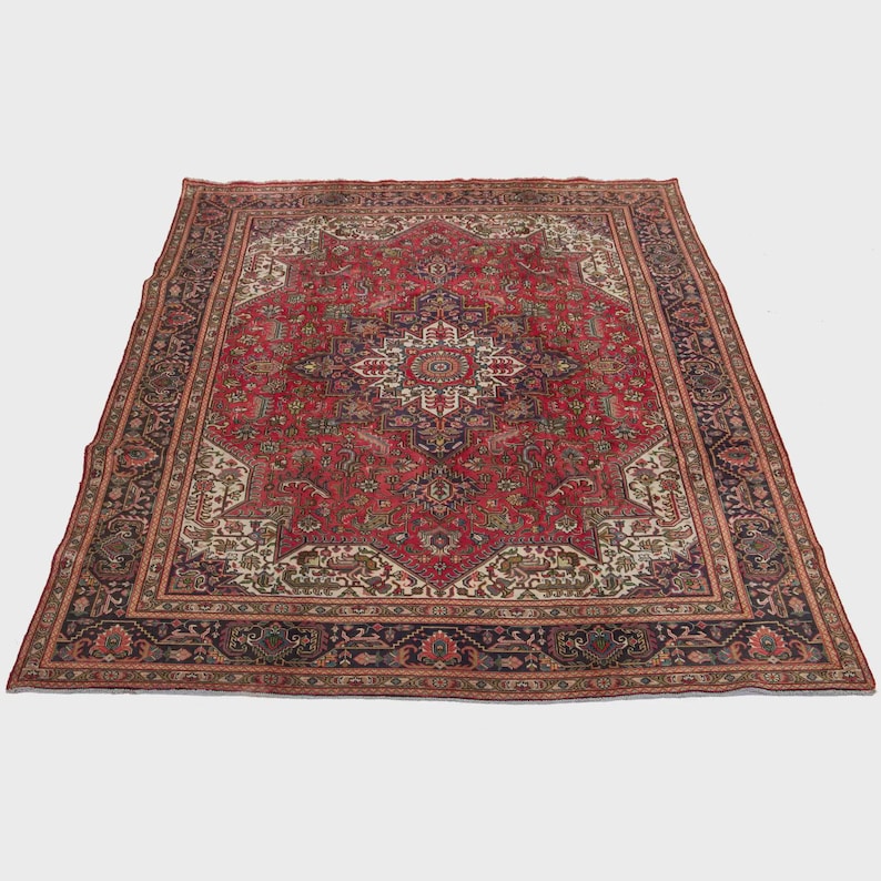 May include: A large, rectangular Persian rug with a central medallion design. The rug features a predominantly red field with intricate floral and geometric patterns in navy, cream, and brown. The border is a dark navy with floral motifs.