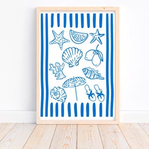 Puede incluir: Un estampado enmarcado con una ilustraci&oacute;n azul y blanca de tem&aacute;tica playera. La obra de arte incluye estrellas de mar, conchas, una rodaja de lim&oacute;n, coral, una sombrilla y sandalias. El fondo tiene rayas verticales azules.