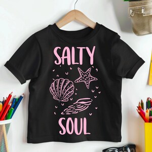 May include: Black t-shirt with a pink graphic that says "Salty Soul" with a seashell and starfish design.