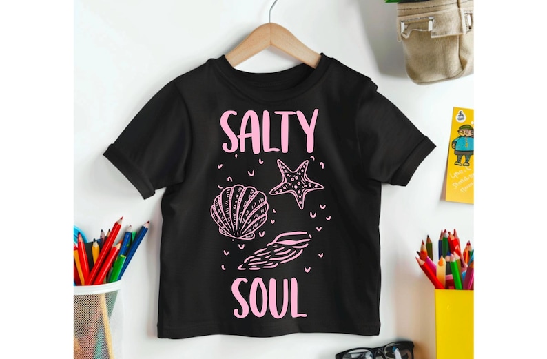 May include: Black t-shirt with a pink graphic that says "Salty Soul" with a seashell and starfish design.
