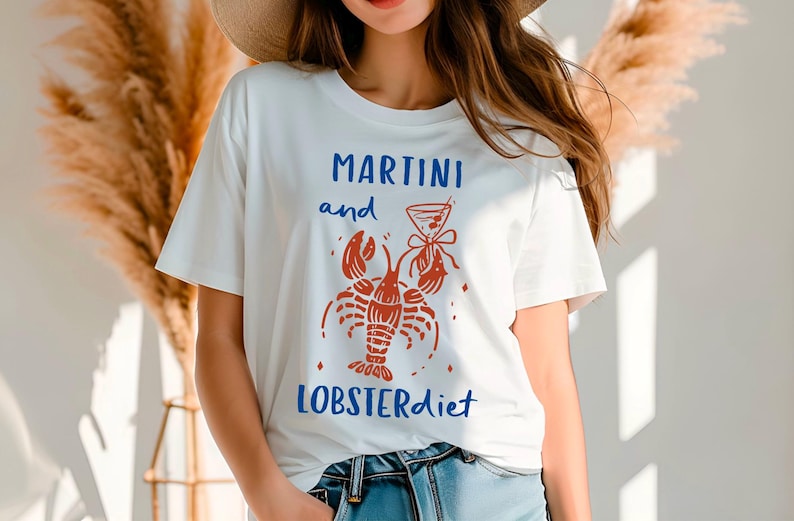 May include: White t-shirt with a red lobster and martini glass graphic and the text "Martini and Lobsterdiet".