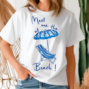 May include: White t-shirt with a blue graphic design that says "Meet me at the beach!" with a beach chair and umbrella.