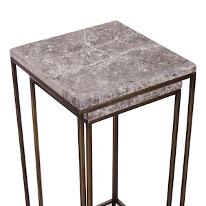 May include: A set of two nesting tables with a gray marble top and a brass frame.