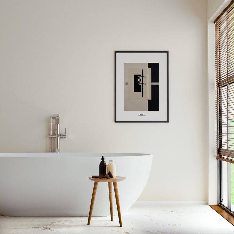 May include: A white bathtub with a chrome faucet, a wooden stool with three legs, and three bottles of bath products. The bathroom has a white wall with a framed black and white abstract art print and a window with brown blinds.