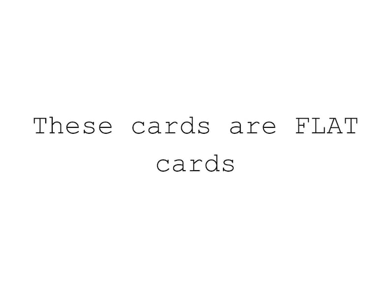May include: White background with the text "These cards are FLAT cards" in a typewriter-style font. The text is centered and in black.