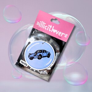 May include: A blue car air freshener with a white background and the text "Vanilla" on the bottom. The air freshener is packaged in a clear plastic bag with a pink header that says "illicitlover".