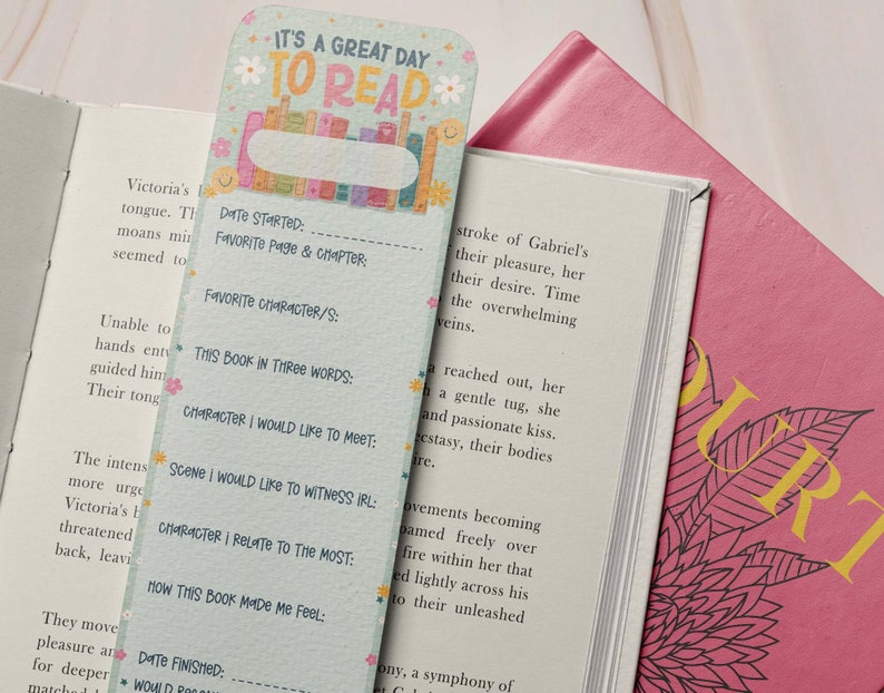 May include: A green and blue bookmark with a floral design and the text "It's a great day to read". The bookmark has sections for recording information about a book, such as the date started, favorite page and chapter, favorite character, and how the book made the reader feel.