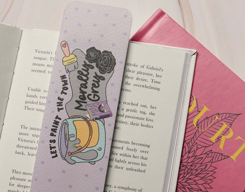 May include: Purple bookmark with a paint can, paintbrush, and a book with the text "Morally Grey" and the words "Let's Paint the Town".