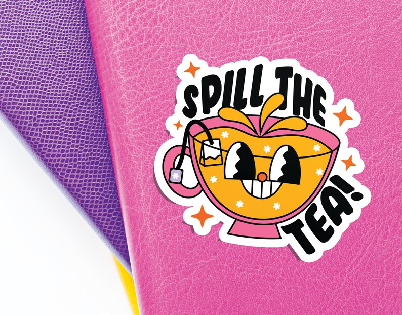 May include: A die-cut sticker featuring a cartoon teacup with a pink base and orange liquid, displaying a smiling face with large eyes. The text 'SPILL THE TEA!' is printed in bold black letters above and below the cup, accented by orange stars.
