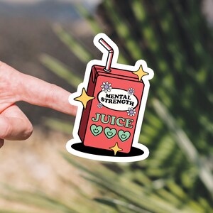 Puede incluir: Una pegatina de una caja de jugo roja con una pajita, flores y el texto "Mental Strength Juice".