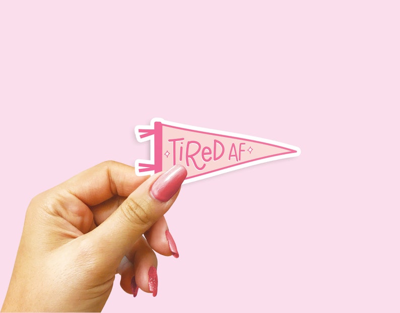 May include: Pink pennant flag sticker with the text "Tired AF" in pink script.