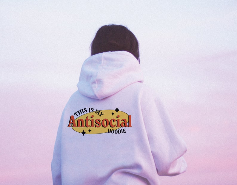 May include: White hoodie with the text "This is my Antisocial Hoodie" in a yellow oval with red text and black outlines. There are small stars around the oval.