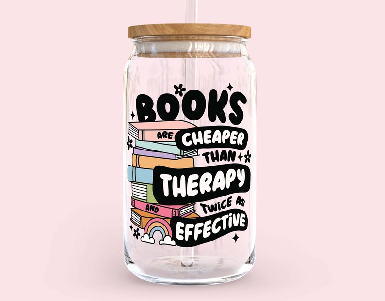 May include: A clear glass jar with a wooden lid and a straw. The jar has a colorful graphic that says "Books are cheaper than therapy and twice as effective".