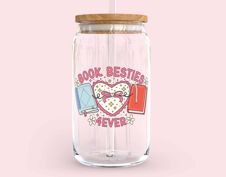 May include: A clear glass reusable water bottle with a wooden lid and a straw. The bottle has a pink and white sticker with the text "Book Besties 4ever" and a heart with two books inside.